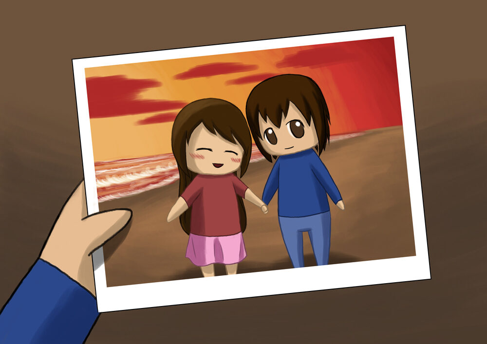 Boy holds the photo of them holding hands and smiling at the beach.